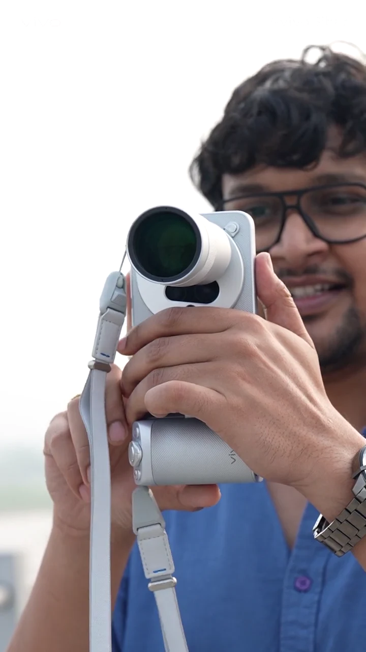 Saurabh Anuraj looking through a vivo X300 Ultra camera accessory